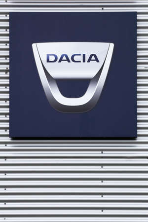 Risskov, Denmark - July 25, 2020: Dacia logo on wall of a dealer. Dacia is a romanian car manufacturer and belong to Renault french groupのeditorial素材