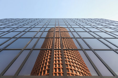 Lyon, France - March 26, 2016: Reflection of the Part-Dieu tower in a facade. The building rises...