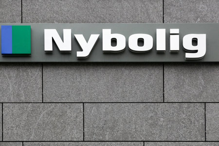 Herning, Denmark - August 18, 2022: Nybolig logo on a wall. Nybolig is a Danish national chain of estate agents with approx. 225 businesses that are part of the Nykredit groupのeditorial素材