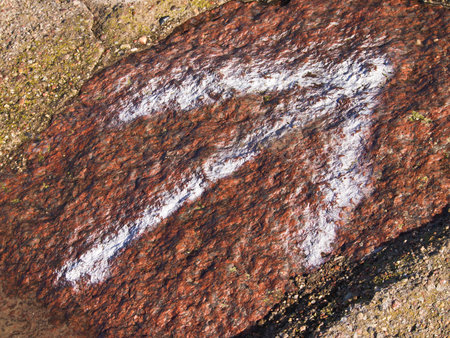 Painted arrow on a stone.