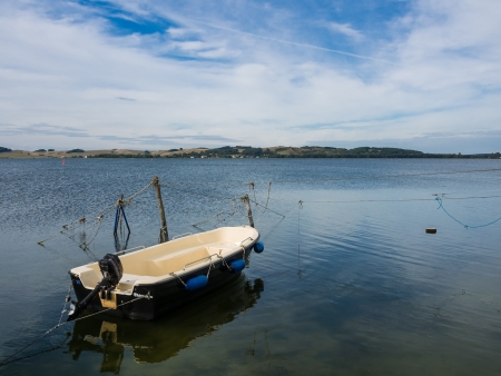 Fishing boat on shore of the Baltic Sea の写真素材
