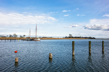 A port with dolphins and sailing ship の写真素材