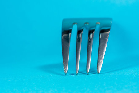 A fork isolated with blue background.の写真素材