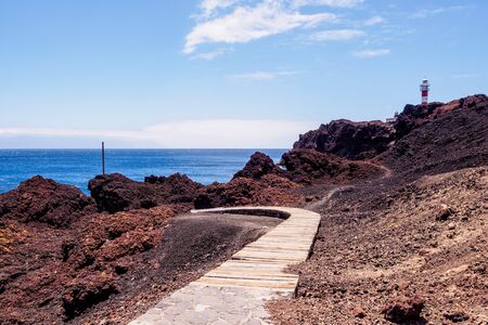 Lighthouse Faro de Punta de Teno on shore of the Atlantic Ocean on the island Tenerife.の写真素材