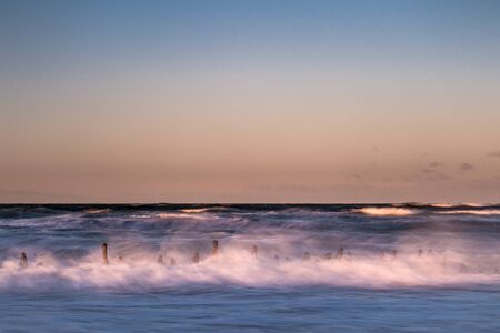 Groynes on shore of the Baltic Sea on a stormy day.の写真素材