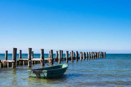 Groyne and fishing boat on the Baltic Sea coast in Zingst (Germany).の写真素材