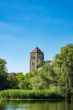 View over the river Warnow to a church in Rostock (Germany).