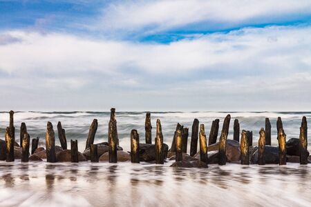 Groynes on shore of the Baltic Sea on a stormy day.の写真素材