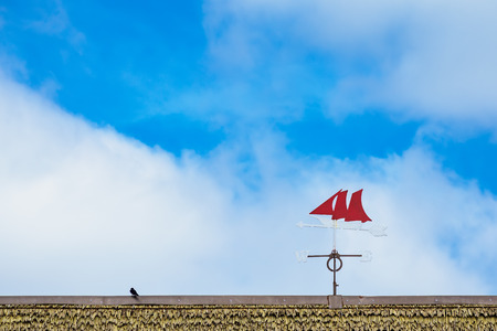 A weather vane on the roof of a building.の写真素材
