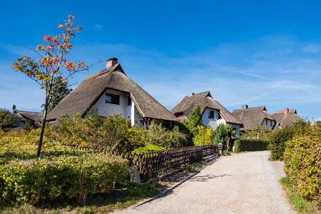 Thatched houses with blue sky in Ahrenshoop, Germany.の写真素材