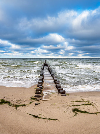 Groynes and waves on shore of the Baltic Sea.の写真素材