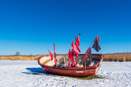 Red fishing boat on the Bodden coast in Althagen, Germany.の写真素材