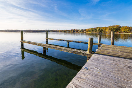 Jetty and trees on the lake Plauer See in the town of Plau am See, Germany.の写真素材
