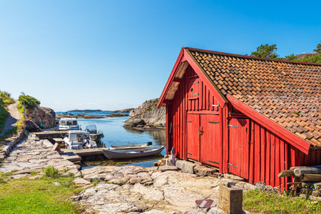 Red boathouse on the archipelago island of Kapelloya in Norway.の写真素材