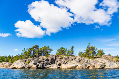 Landscape with rocks and trees on an island near Vastervik in Sweden.の写真素材