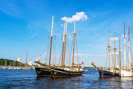 Sailing ships on the river Warnow during the Hanse Sail in Rostock, Germany.の写真素材