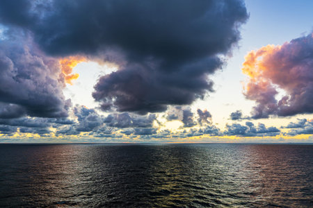View over the Baltic Sea with clouds and sunset.
