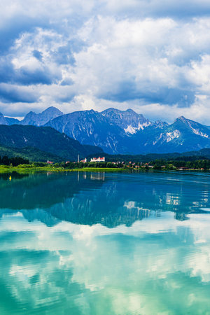 View over the Forggensee lake to Fuessen and the Allgau Alps, Germany.の写真素材