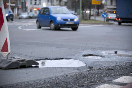 pot-hole in a street with many trafficの写真素材