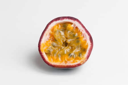 halved passion fruit on white backgroundの写真素材