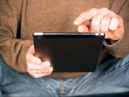 two Hands holding Tablet and tap text