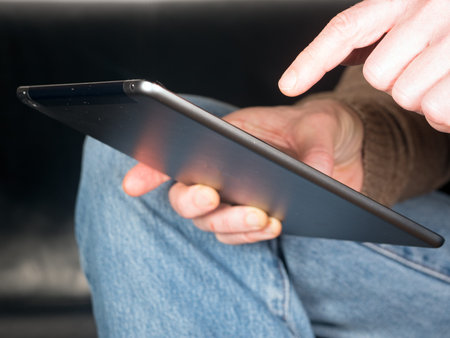 two Hands holding Tablet and tap text