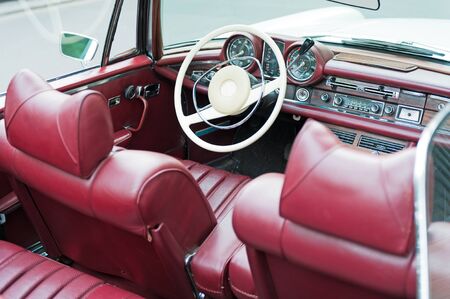 Interior of an old cabriolet with red leather seatsの写真素材