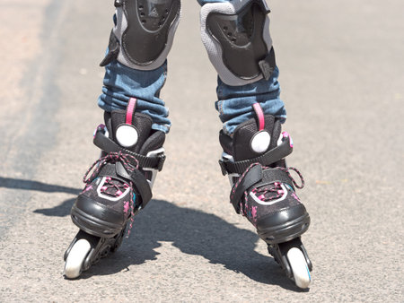 legs of a child driving Roller Skates