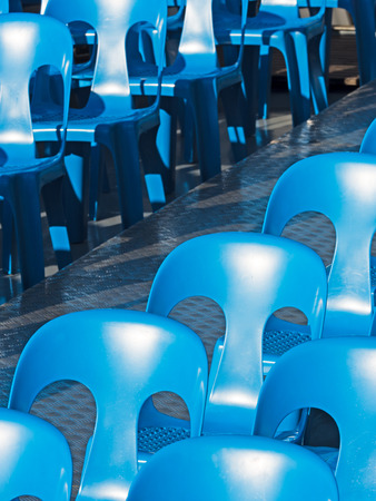 blue chairs standing in a diagonal rowの写真素材