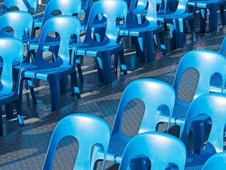 blue chairs standing in a diagonal rowの写真素材