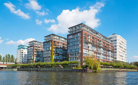 Four modern apartment buildings at a waterfrontの写真素材