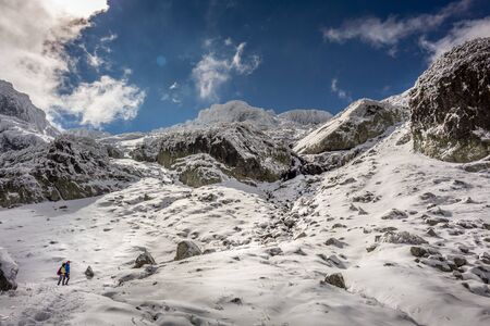 Two people staring in the amazing winter landscape at the Rila Mountain in Bulgaria, Maliovica.の写真素材