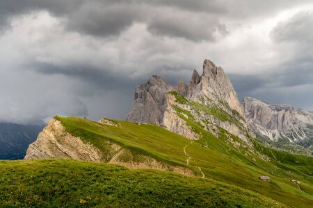 Pearson watching the incoming storm at the Seceda peak at the beautiful Val Gardena valley in Dolomites mountains, Alps, Italy.の写真素材