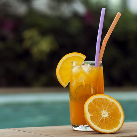Orange juice around a swimming poolの写真素材