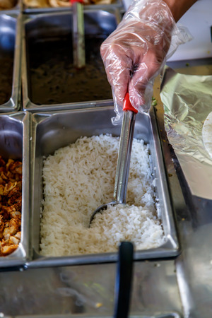 Tray with cooked food on showcaseの写真素材