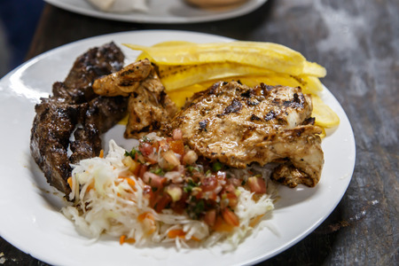 traditional nicaraguan cuisine, roast meat, salad and fried banana.の写真素材