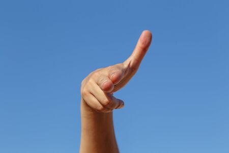 hand of show gun with sky at backgroundの写真素材