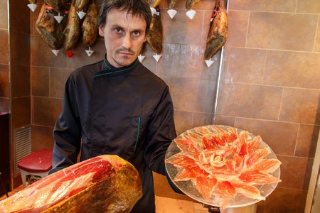 jamon iberico, spanish ham, with manの写真素材