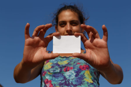 girl showing an empty white card
