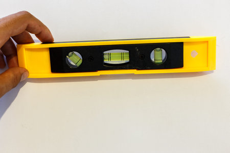 Yellow spirit level isolated on white background.