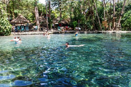 Ojo de Agua, Ometepe island, Nicaragua- March 31 2015: People swimming in waterのeditorial素材