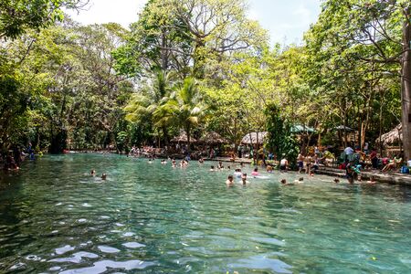 Ojo de Agua, Ometepe island, Nicaragua- March 31 2015: People swimming in waterのeditorial素材