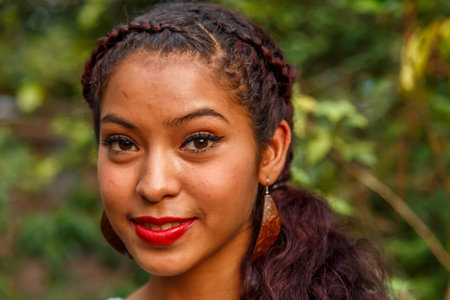 atractive latin woman showing handmade coconut earrings in nature