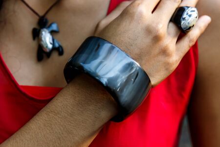Woman wearing a handmade bracelet while hanging outsideの写真素材