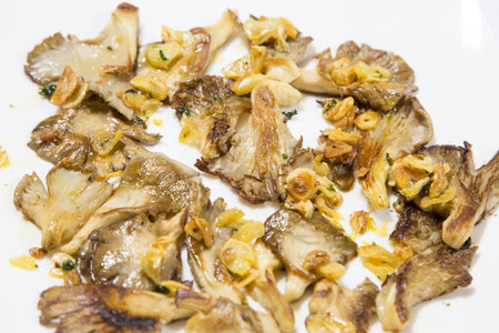 Pickled Mushrooms with dill and garlic on the white plateの写真素材
