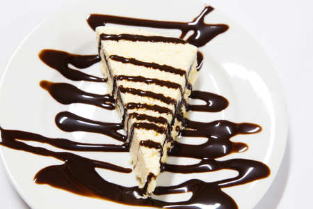 white cake portion with chocolate served on dishの写真素材