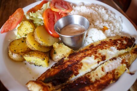 grill fish served with rice and vegetablesの写真素材