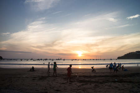 San Juan del Sur, Nicaragua â March 9, 2016: sunset with people on beachのeditorial素材