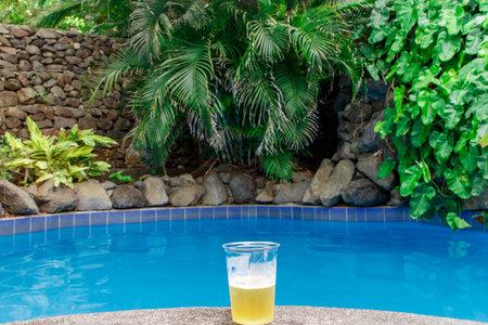 beer on plastic glass on pool