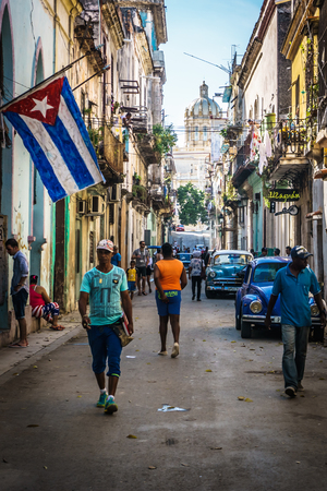 Cuban street view with people and cuban flag, on december 26, 2016, in La Havana, Cubaのeditorial素材